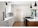 Bright modern kitchen features white cabinets, quartz counters, and hardwood floors at 521 W Cambridge Ave, Phoenix, AZ 85003