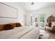 Bright main bedroom features a king size bed and access to an outdoor patio at 521 W Cambridge Ave, Phoenix, AZ 85003
