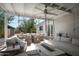Inviting outdoor patio with comfortable seating, a dining area, ceiling fan, and a modern gas fire pit at 521 W Cambridge Ave, Phoenix, AZ 85003