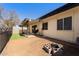 Backyard featuring a fire pit, artificial grass, and a covered patio at 5342 S Farmer Ave, Tempe, AZ 85283