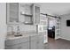 Stylish bar area with granite countertops, cabinets, open shelving, and a sliding barn door at 5342 S Farmer Ave, Tempe, AZ 85283