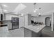 Bright kitchen with stainless appliances and an island, opening to the dining and living areas at 5342 S Farmer Ave, Tempe, AZ 85283