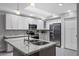 Modern kitchen featuring white cabinets, stainless steel appliances, granite countertops, and ample natural light at 5342 S Farmer Ave, Tempe, AZ 85283