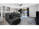Spacious living room featuring modern decor, sliding glass doors to the patio, and lots of sunlight at 5342 S Farmer Ave, Tempe, AZ 85283