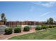 Community pool with black metal fence, manicured landscaping, parking spots, and shaded seating at 5342 S Farmer Ave, Tempe, AZ 85283