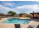 Community pool with lounge chairs, outdoor shower, shaded seating, and well-maintained pool deck at 5342 S Farmer Ave, Tempe, AZ 85283
