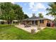 Expansive backyard with a patio, mature trees, and manicured lawn at 7254 E Vernon Ave, Scottsdale, AZ 85257