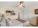 Light-filled bedroom featuring a ceiling fan, closet, and plush bedding at 7254 E Vernon Ave, Scottsdale, AZ 85257