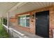 Inviting front entrance with a black security door and view to side street at 7254 E Vernon Ave, Scottsdale, AZ 85257