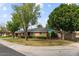 Inviting single-story brick home with a well-maintained lawn and beautiful mature landscaping at 7254 E Vernon Ave, Scottsdale, AZ 85257