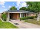 Charming single-story brick home with a well-manicured lawn and mature trees at 7254 E Vernon Ave, Scottsdale, AZ 85257