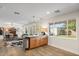 Open-concept kitchen with a granite-topped island, modern lighting, and warm wood floors at 7254 E Vernon Ave, Scottsdale, AZ 85257