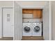 A laundry room with a stacked washer and dryer and built-in storage at 7254 E Vernon Ave, Scottsdale, AZ 85257