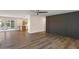 Open living space with wood-look floors, a custom accent wall, and seamless flow to the outdoors at 7254 E Vernon Ave, Scottsdale, AZ 85257