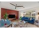 Bright living room featuring a blue sofa, decorative fireplace, and ample natural light at 7254 E Vernon Ave, Scottsdale, AZ 85257