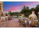 Backyard with a pizza oven, an outdoor seating area, and lush green trees at 7471 E Desert Vista Rd, Scottsdale, AZ 85255