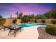 Backyard featuring a pool, lounge chairs, and beautiful desert landscaping at 7471 E Desert Vista Rd, Scottsdale, AZ 85255