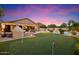 Backyard featuring a pool, an outdoor kitchen, and a putting green at 7471 E Desert Vista Rd, Scottsdale, AZ 85255