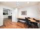 A functional office space with hardwood floors, ample desk space, and an open doorway to the living space at 7471 E Desert Vista Rd, Scottsdale, AZ 85255