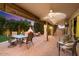 Charming patio with a pizza oven, ceiling fan, and outdoor seating for relaxing evenings at 7471 E Desert Vista Rd, Scottsdale, AZ 85255