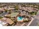 Aerial view of neighborhood with a community pool and tennis courts amidst mature landscaping at 8100 E Camelback Rd # 138, Scottsdale, AZ 85251