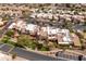 Aerial view of a neighborhood, featuring well-maintained homes, mature trees, and lush landscaping at 8100 E Camelback Rd # 138, Scottsdale, AZ 85251