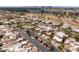Aerial view of desert community showcasing lush landscaping, tennis courts, and well-maintained streets at 8100 E Camelback Rd # 138, Scottsdale, AZ 85251