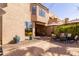 Backyard with a patio, dining and seating area, desert landscaping and beautiful blue planters at 8100 E Camelback Rd # 138, Scottsdale, AZ 85251