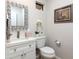 Stylish powder room with decorative mirror, vanity, and white fixtures at 8100 E Camelback Rd # 138, Scottsdale, AZ 85251