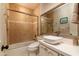 Contemporary bathroom with a sleek vanity, vessel sink, and modern fixtures with a glass enclosed tub at 8100 E Camelback Rd # 138, Scottsdale, AZ 85251