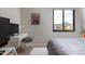 Sunlit bedroom featuring a desk, ceiling fan, a stylish rug, and scenic views at 8100 E Camelback Rd # 138, Scottsdale, AZ 85251