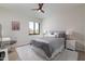 Bright bedroom featuring a ceiling fan, comfortable bedding and a large window at 8100 E Camelback Rd # 138, Scottsdale, AZ 85251