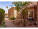 Exterior view with lush landscaping and a charming patio area with a comfortable outdoor seat at 8100 E Camelback Rd # 138, Scottsdale, AZ 85251