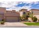 Inviting two-story home showcasing a charming exterior with a well-kept lawn and covered garage at 8100 E Camelback Rd # 138, Scottsdale, AZ 85251
