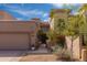 Beautiful home featuring a well-manicured lawn, covered garage, and lush trees at 8100 E Camelback Rd # 138, Scottsdale, AZ 85251