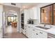 Bright kitchen featuring white cabinets, stainless steel appliances, and an open floor plan to the dining area at 8100 E Camelback Rd # 138, Scottsdale, AZ 85251