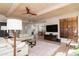 Open concept living room, showcasing beamed ceiling, television, and fireplace at 8100 E Camelback Rd # 138, Scottsdale, AZ 85251