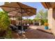 Inviting patio with comfortable seating under large umbrellas, perfect for outdoor entertaining and relaxation at 8100 E Camelback Rd # 138, Scottsdale, AZ 85251