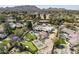 Estate aerial view showing putting green, swimming pool and tennis court amid mountain views at 8817 N 58Th Pl, Paradise Valley, AZ 85253
