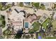 Aerial view showcasing a resort-style backyard with pool, pickleball court and manicured lawn at 8817 N 58Th Pl, Paradise Valley, AZ 85253