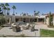 A spacious backyard offers a pool, fire pit, outdoor seating, and manicured landscaping at 8817 N 58Th Pl, Paradise Valley, AZ 85253