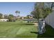 The backyard boasts a putting green, sand trap, and lush lawn, ideal for golfers at 8817 N 58Th Pl, Paradise Valley, AZ 85253