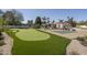 An outdoor space features a putting green, pickleball court, and ample landscaping for recreation and relaxation at 8817 N 58Th Pl, Paradise Valley, AZ 85253