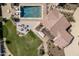 Aerial view of backyard featuring pool, spa, firepit, and outdoor dining area at 8817 N 58Th Pl, Paradise Valley, AZ 85253