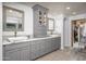 Bathroom featuring double sinks, granite countertops, custom cabinets, and modern fixtures at 8817 N 58Th Pl, Paradise Valley, AZ 85253
