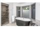 Luxurious bathroom featuring a soaking tub and a glass-enclosed shower, offers a spa-like experience at 8817 N 58Th Pl, Paradise Valley, AZ 85253