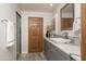 Bathroom with a walk-in shower, white countertops, and wooden accents for a comfortable and functional space at 8817 N 58Th Pl, Paradise Valley, AZ 85253