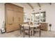 Cozy dining area with modern table and chairs, cabinetry and view to the backyard at 8817 N 58Th Pl, Paradise Valley, AZ 85253