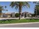 Beautiful home with well-maintained landscaping, complemented by a vibrant palm tree lined street at 8817 N 58Th Pl, Paradise Valley, AZ 85253