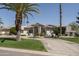 Beautiful single-story home with a circular driveway, lush landscaping, and desert foliage at 8817 N 58Th Pl, Paradise Valley, AZ 85253